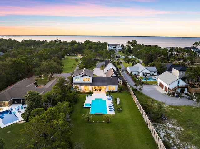 aerial view at dusk with a water view