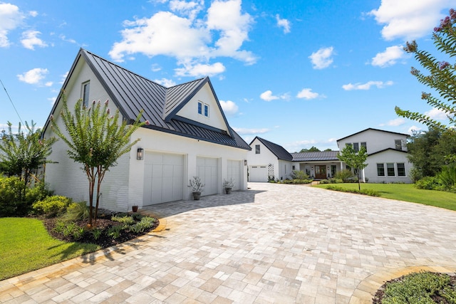 view of side of home with a yard and a garage