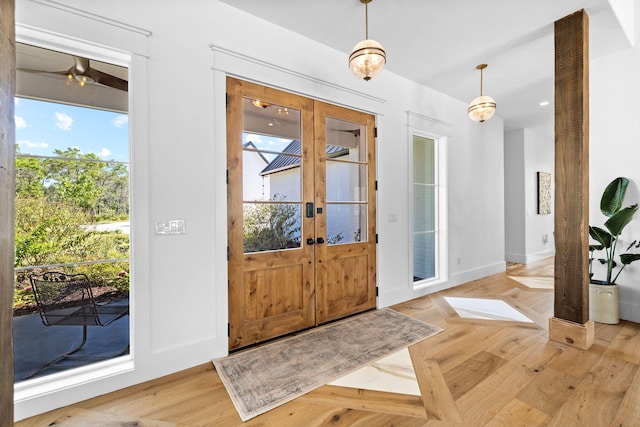 entryway with french doors, plenty of natural light, and light parquet flooring