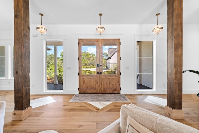 foyer featuring light wood-type flooring and french doors