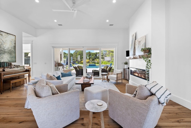 living room featuring light wood-type flooring and ceiling fan