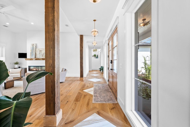 foyer entrance featuring ceiling fan and light hardwood / wood-style floors