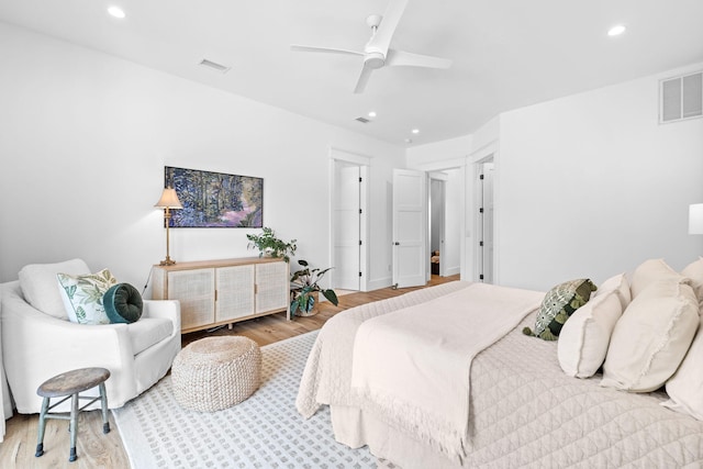 bedroom with ceiling fan and light hardwood / wood-style floors