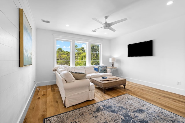 living room with ceiling fan and light hardwood / wood-style floors