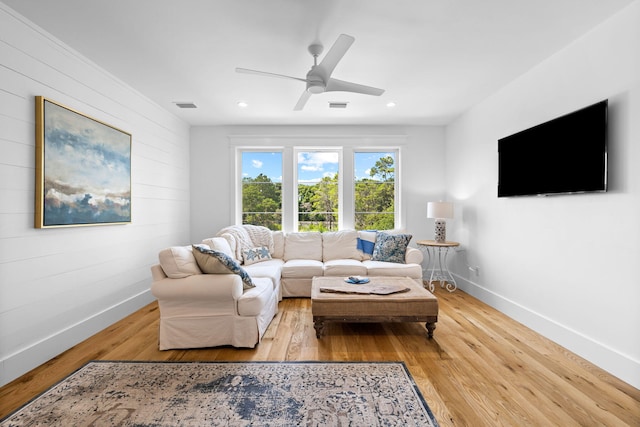 living room with ceiling fan and light wood-type flooring