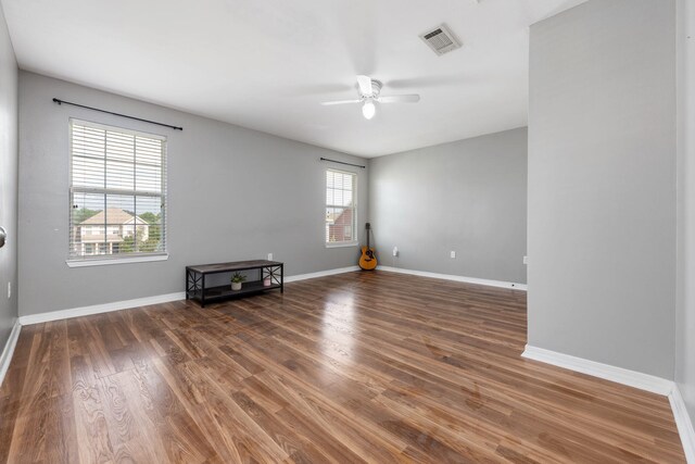 empty room with ceiling fan and hardwood / wood-style flooring