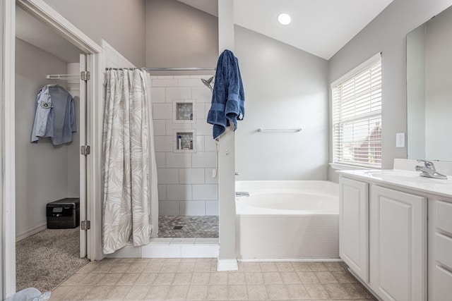 bathroom featuring vanity, vaulted ceiling, tile patterned flooring, and independent shower and bath