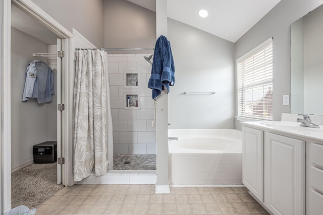 bathroom with lofted ceiling, tiled shower, vanity, and a bath