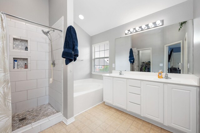 bathroom with tile patterned floors, shower with separate bathtub, double sink vanity, and lofted ceiling