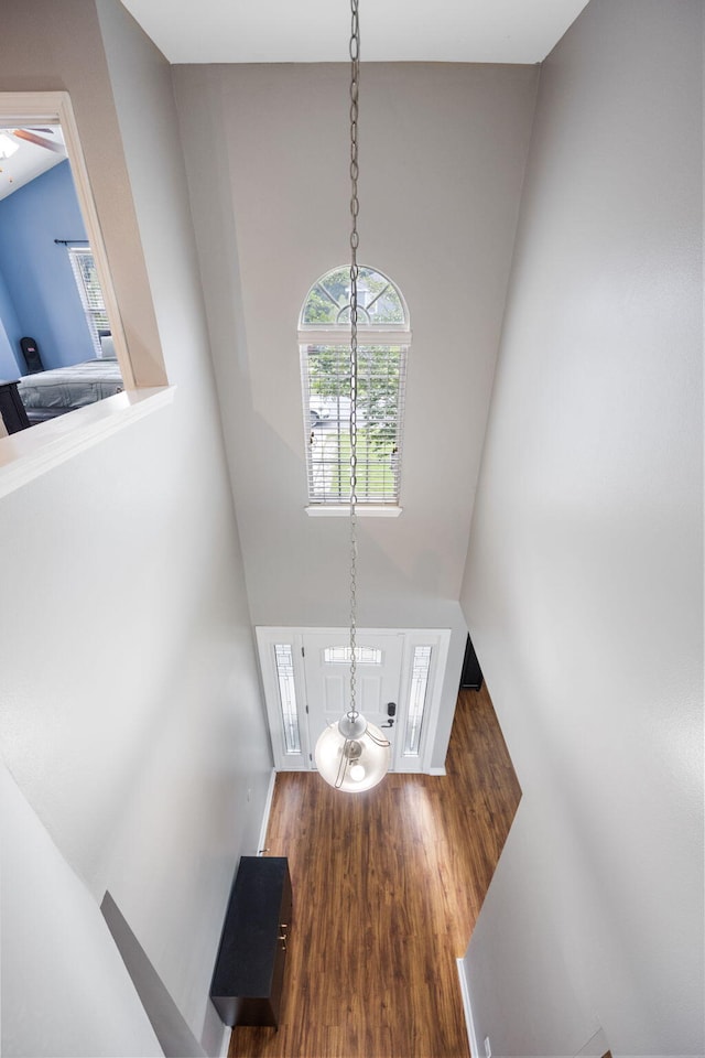 entryway featuring wood finished floors and an inviting chandelier