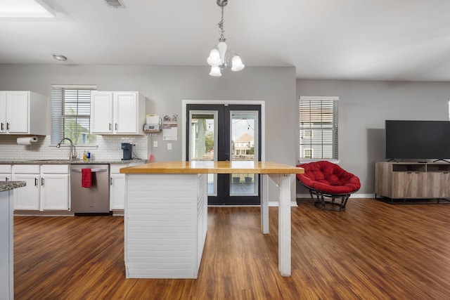 kitchen with dark wood-type flooring, dishwasher, and white cabinetry