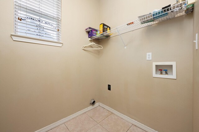 laundry area with laundry area, baseboards, hookup for an electric dryer, washer hookup, and light tile patterned flooring