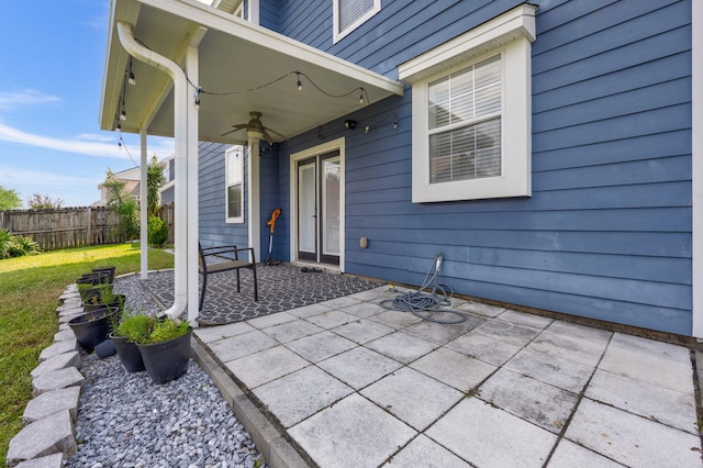 view of patio featuring fence and a ceiling fan