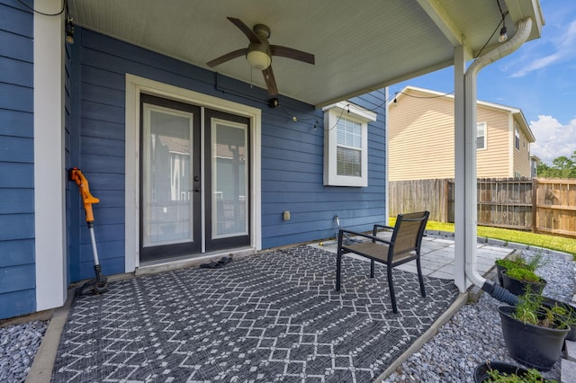 view of patio with ceiling fan and fence