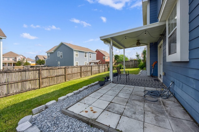 view of patio with ceiling fan, a fenced backyard, and a residential view