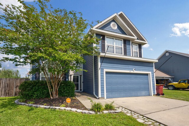 view of front of house with a garage and a front lawn