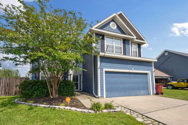 traditional-style home featuring a garage, concrete driveway, a front yard, and fence