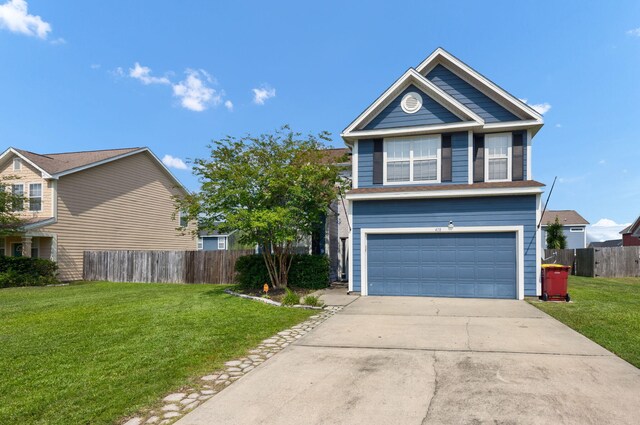 view of front of property with a front yard and a garage