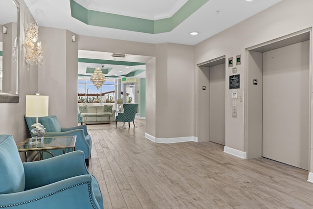 15100 Emerald Coast Pkwy Ph 2, Destin, FL 32541 - interior space with light wood-style floors, elevator, a raised ceiling, and baseboards