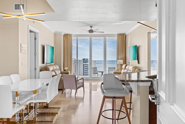 15100 Emerald Coast Pkwy Ph 2, Destin, FL 32541 - dining room with ornamental molding, expansive windows, visible vents, and a ceiling fan