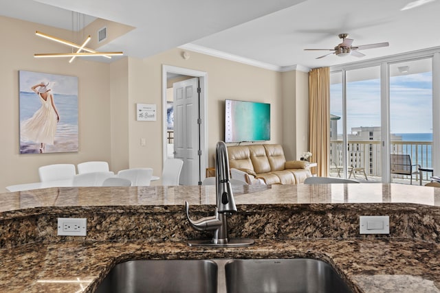 15100 Emerald Coast Pkwy Ph 2, Destin, FL 32541 - kitchen with visible vents, ornamental molding, open floor plan, dark stone countertops, and a sink