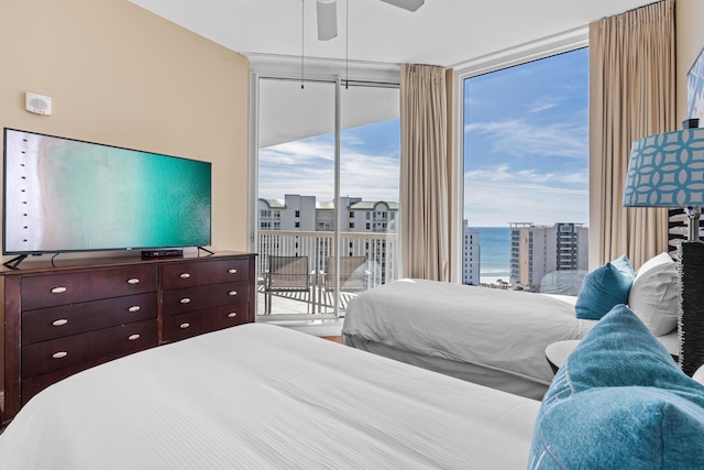 15100 Emerald Coast Pkwy Ph 2, Destin, FL 32541 - bedroom featuring a water view, access to exterior, ceiling fan, and expansive windows