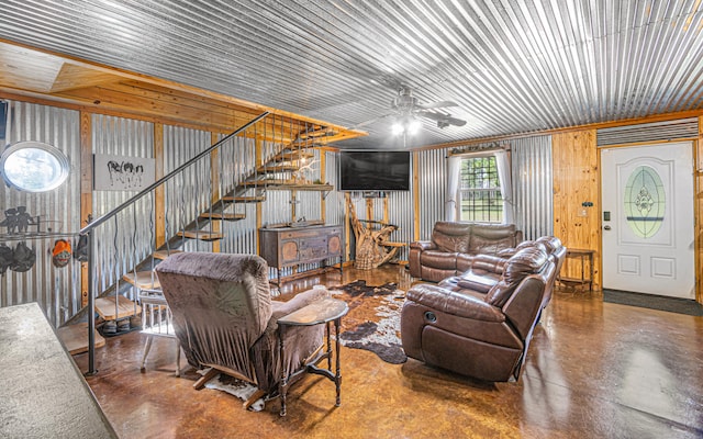 living room featuring ceiling fan and concrete floors