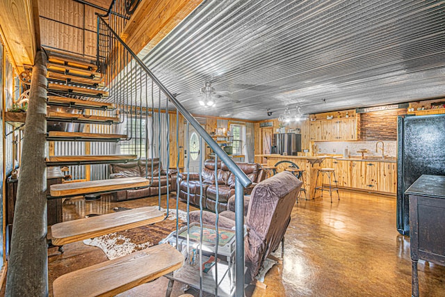 stairway featuring ceiling fan