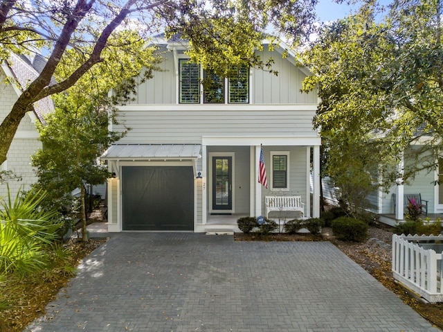 view of front of house featuring a porch and a garage