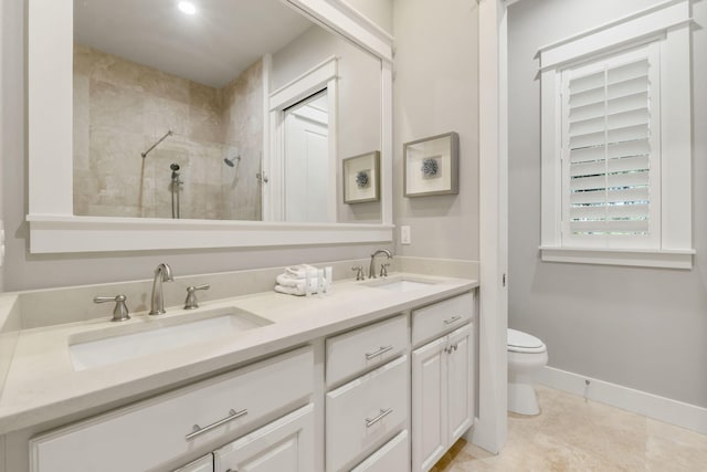 bathroom featuring vanity, tile patterned floors, toilet, and a tile shower