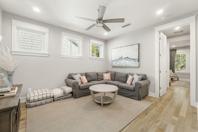 living room with ceiling fan and light wood-type flooring