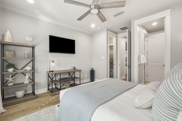 bedroom with light hardwood / wood-style floors and ceiling fan