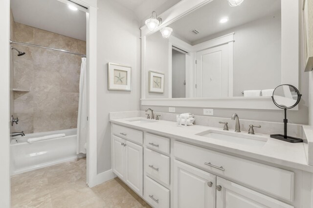 bathroom featuring shower / bath combo and vanity