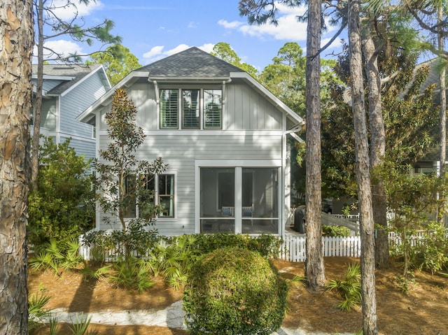 view of side of property with a sunroom