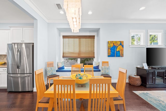 dining area with ornamental molding, dark hardwood / wood-style floors, and a notable chandelier