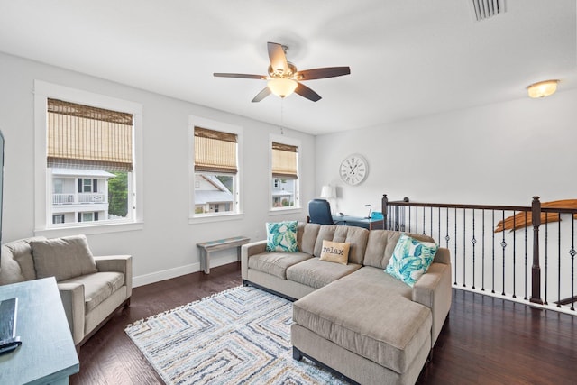 living room with dark hardwood / wood-style flooring and ceiling fan