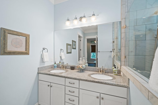 bathroom featuring vanity, crown molding, and a tile shower