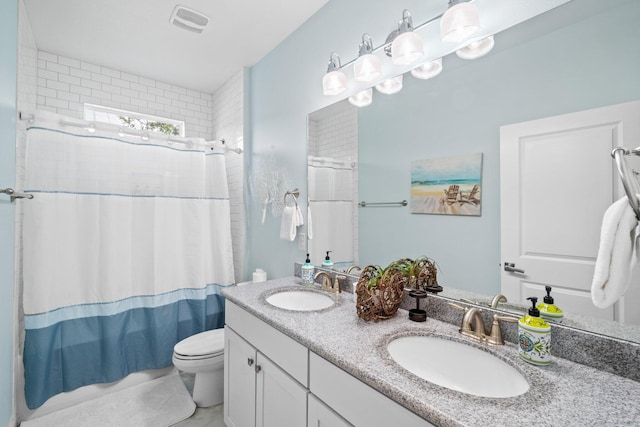 bathroom with vanity, toilet, and curtained shower