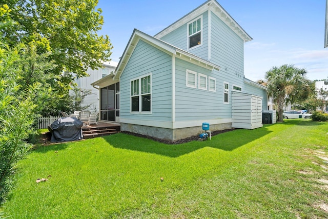 rear view of property with a yard