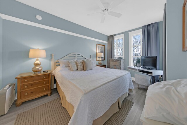 bedroom featuring ceiling fan and light hardwood / wood-style flooring