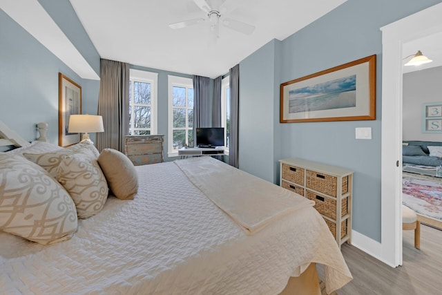 bedroom with ceiling fan and hardwood / wood-style flooring