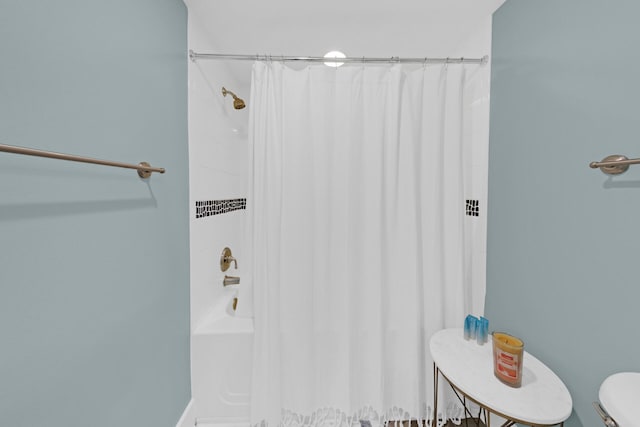 bathroom with toilet and shower / tub combo with curtain