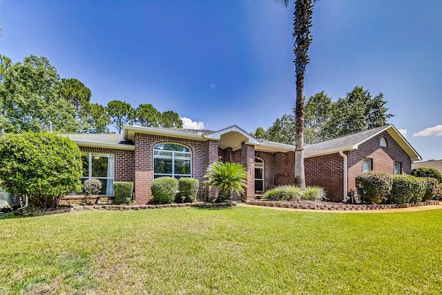 ranch-style home featuring a front yard