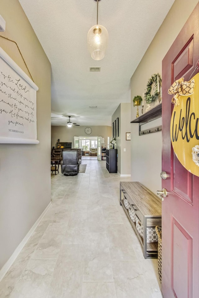 hall featuring light tile patterned floors