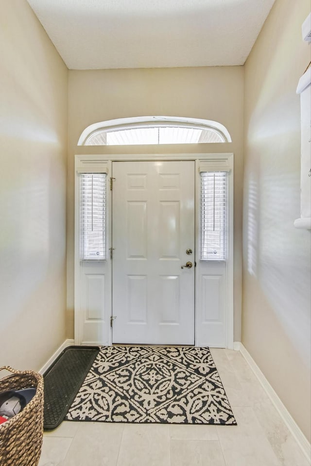 entryway featuring light tile patterned floors and a wealth of natural light