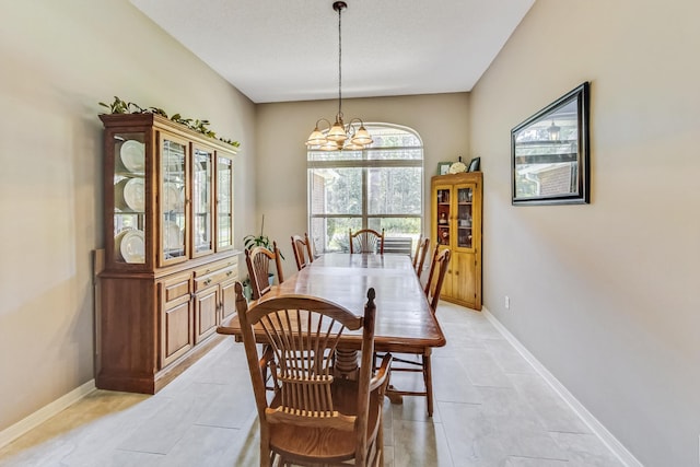 tiled dining area with an inviting chandelier