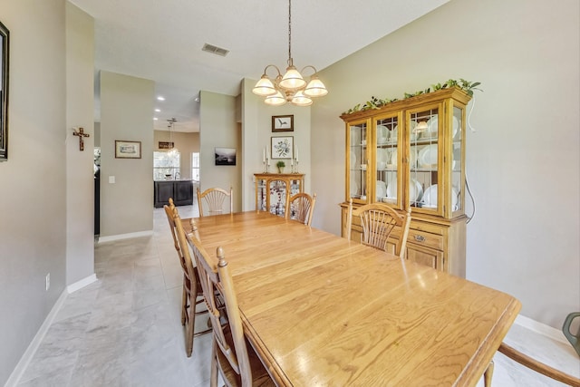 dining area with an inviting chandelier and light tile patterned floors