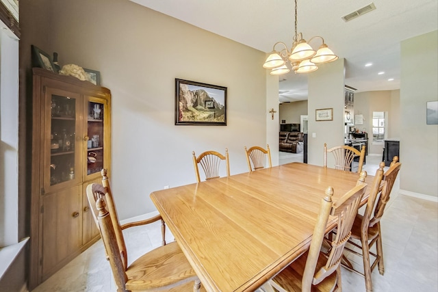 dining area featuring light tile patterned floors and a chandelier