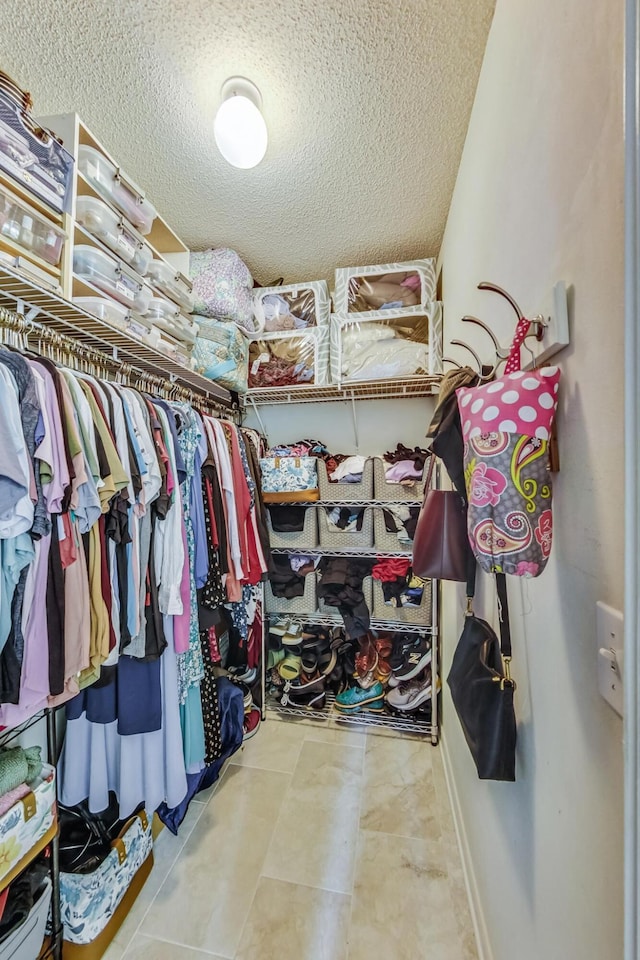 walk in closet featuring light tile patterned floors