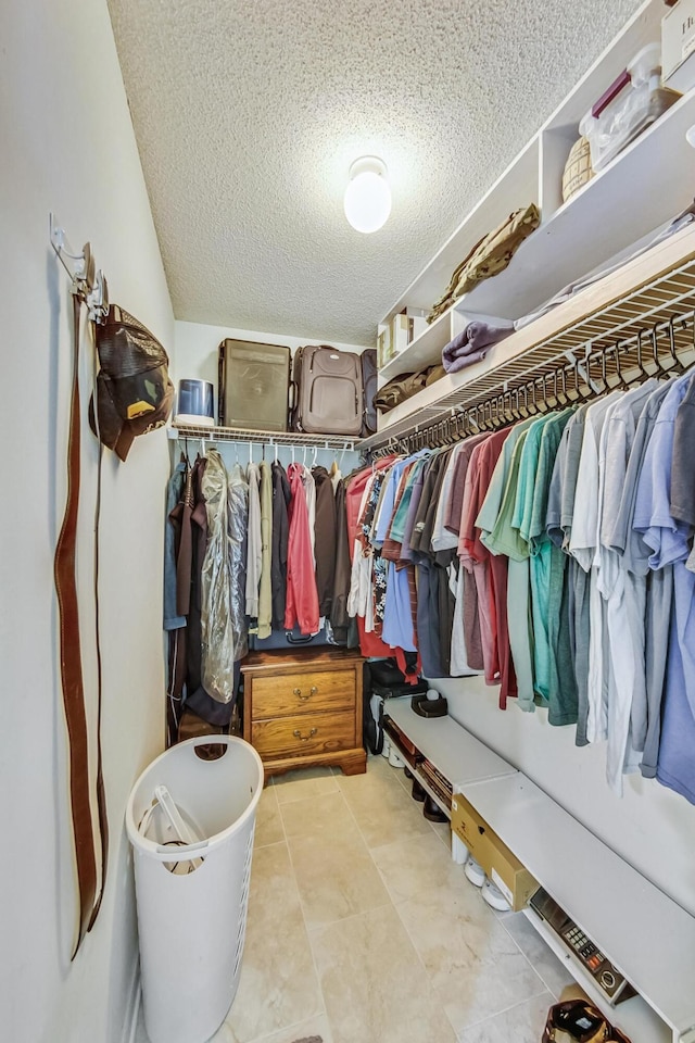 walk in closet with light tile patterned flooring